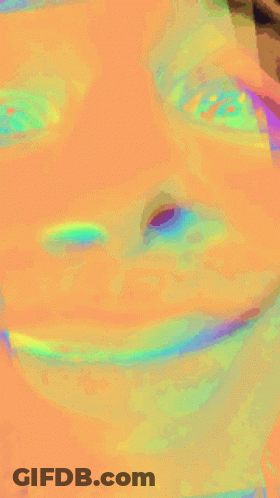 A Close Up Of A Person 'S Face With A Rainbow Of Colors GIF