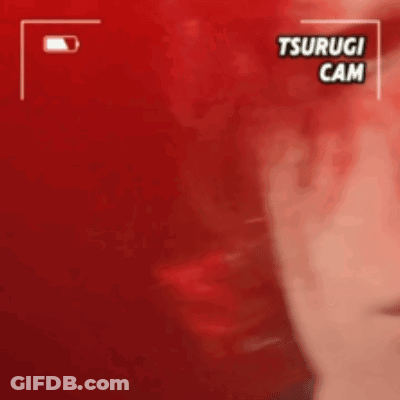A Close Up Of A Person 'S Face With A Red Background And The Words Tsurugi Cam On It . GIF