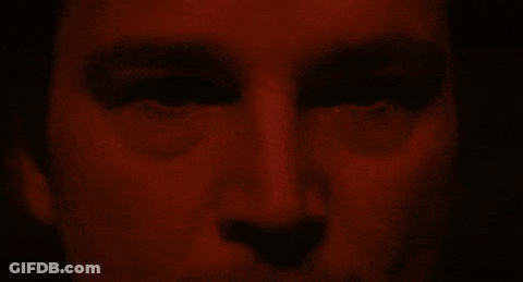 A Close Up Of A Person 'S Face With A Red Background GIF