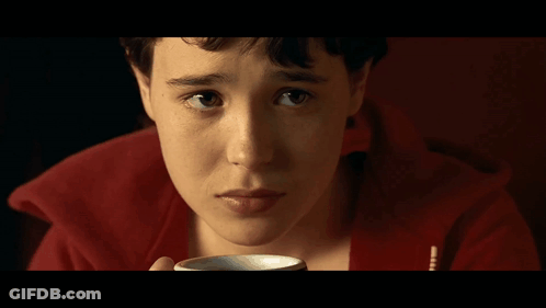A Close Up Of A Person 'S Face With A Red Sweater On GIF