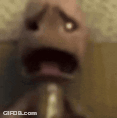 A Close Up Of A Person 'S Face With A Saxophone In His Mouth . GIF