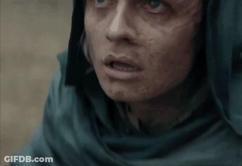 A Close Up Of A Person 'S Face With A Scarf Around Their Head GIF