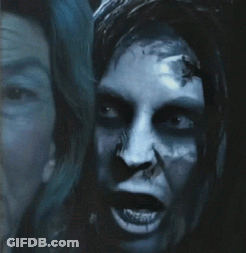 A Close Up Of A Person 'S Face With A Scary Look On Their Face GIF