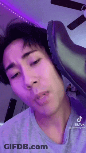 A Close Up Of A Person 'S Face With A Shoe On It . GIF