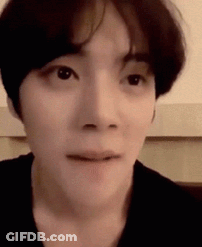 A Close Up Of A Person 'S Face With A Slight Smile On Their Face . GIF