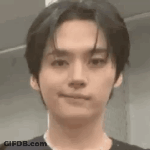 A Close Up Of A Person 'S Face With A Slight Smile On Their Face . GIF