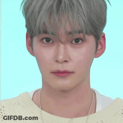 A Close Up Of A Person 'S Face With A Smiley Face Behind Them GIF