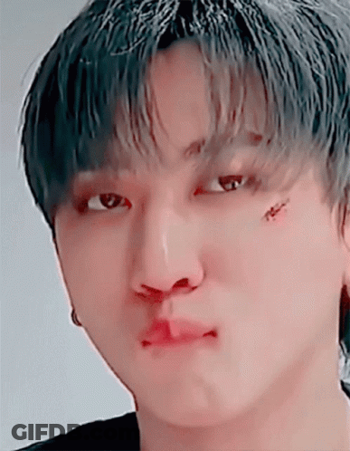 A Close Up Of A Person 'S Face With A Tattoo On Their Face GIF