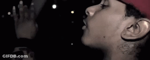 A Close Up Of A Person 'S Face With A Tattoo On Their Neck . GIF