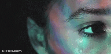 A Close Up Of A Person 'S Face With A Tear Coming Out Of It . GIF