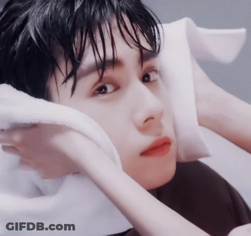 A Close Up Of A Person 'S Face With A Towel On Their Head GIF