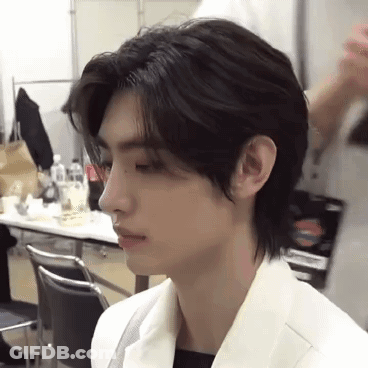 A Close Up Of A Person 'S Face With A Very Long Haircut . GIF