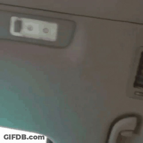 A Close Up Of A Person 'S Face With A White Light On The Ceiling GIF