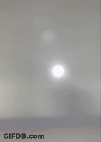 A Close Up Of A Person 'S Face With A White Light Shining On It GIF