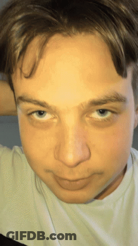 A Close Up Of A Person 'S Face With A White Shirt GIF