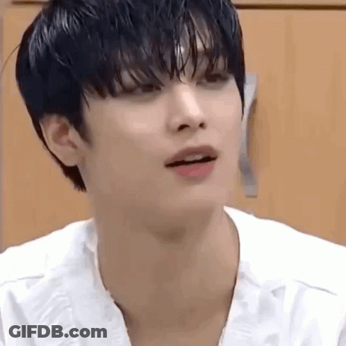 A Close Up Of A Person 'S Face With A White Shirt On And A Black Haircut . GIF
