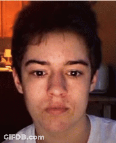 A Close Up Of A Person 'S Face With A White Shirt GIF