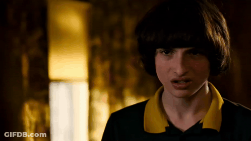 A Close Up Of A Person 'S Face With A Yellow Collar And A Black Shirt . GIF