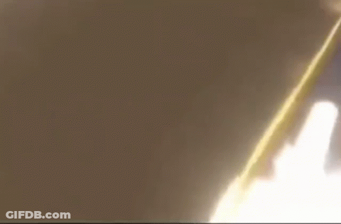 A Close Up Of A Person 'S Face With A Yellow Flame Coming Out Of It 'S Mouth . GIF