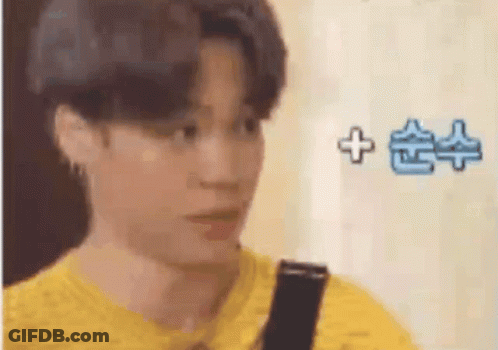 A Close Up Of A Person 'S Face With A Yellow Shirt And A Black Strap . GIF