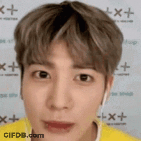A Close Up Of A Person 'S Face With A Yellow Shirt And Headphones On . GIF