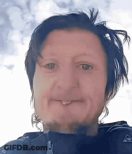 A Close Up Of A Person 'S Face With A Zipper On Their Jacket Visible GIF