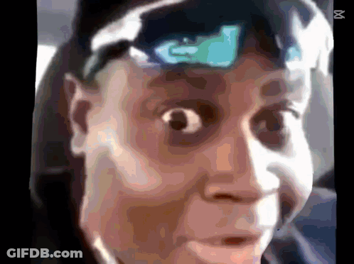 A Close Up Of A Person 'S Face With An X On The Bottom Left GIF