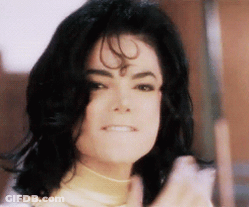 A Close Up Of A Person 'S Face With Black Hair And A Smile GIF