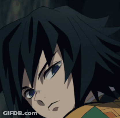 A Close Up Of A Person 'S Face With Black Hair And Green Eyes GIF