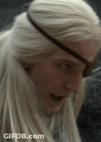 A Close Up Of A Person 'S Face With Blonde Hair And An Eye Patch GIF