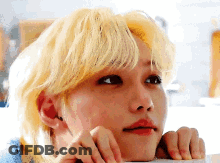 A Close Up Of A Person 'S Face With Blonde Hair And Red Lips . GIF