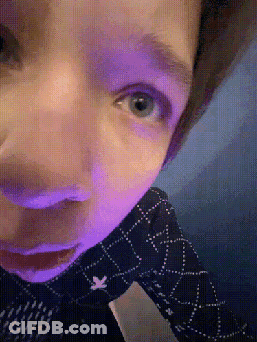 A Close Up Of A Person 'S Face With Blue Eyes GIF