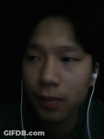 A Close Up Of A Person 'S Face With Ear Buds On GIF