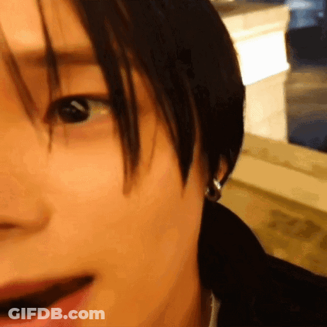 A Close Up Of A Person 'S Face With Earrings On GIF
