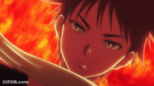 A Close Up Of A Person 'S Face With Fire Behind Them GIF