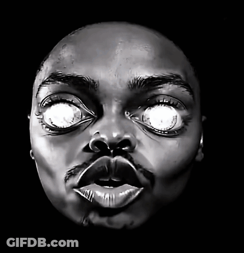 A Close Up Of A Person 'S Face With Glowing Eyes GIF
