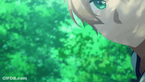 A Close Up Of A Person 'S Face With Green Eyes And Trees In The Background GIF