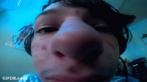 A Close Up Of A Person 'S Face With Headphones GIF
