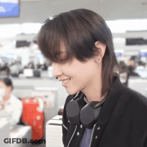 A Close Up Of A Person 'S Face With Headphones On GIF