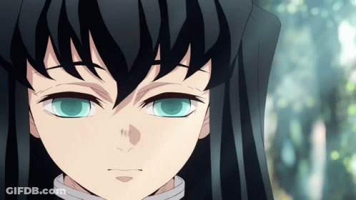A Close Up Of A Person 'S Face With Long Black Hair And Blue Eyes GIF