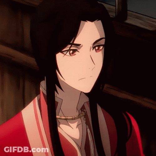 A Close Up Of A Person 'S Face With Long Black Hair And Red Eyes GIF