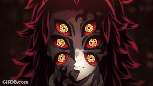 A Close Up Of A Person 'S Face With Many Eyes And Red Hair . GIF