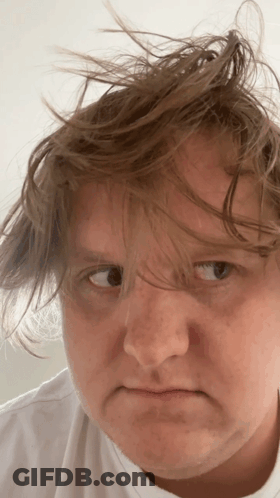 A Close Up Of A Person 'S Face With Messy Hair GIF