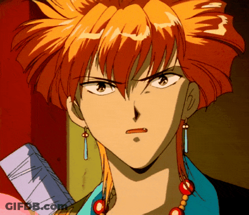 A Close Up Of A Person 'S Face With Orange Hair And Earrings GIF