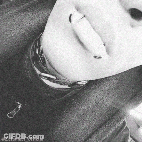 A Close Up Of A Person 'S Face With Piercings On Their Lips And Neck . GIF