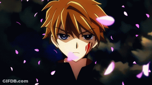A Close Up Of A Person 'S Face With Pink Petals Falling Around Him GIF