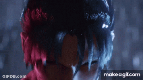 A Close Up Of A Person 'S Face With Red And Black Hair . GIF