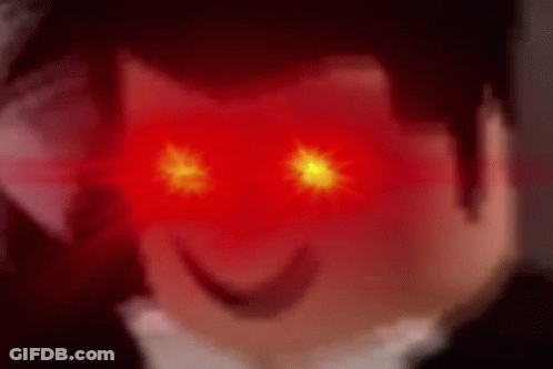 A Close Up Of A Person 'S Face With Red Eyes And A Smile On Their Face . GIF