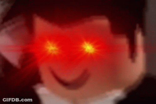 A Close Up Of A Person 'S Face With Red Eyes Glowing . GIF