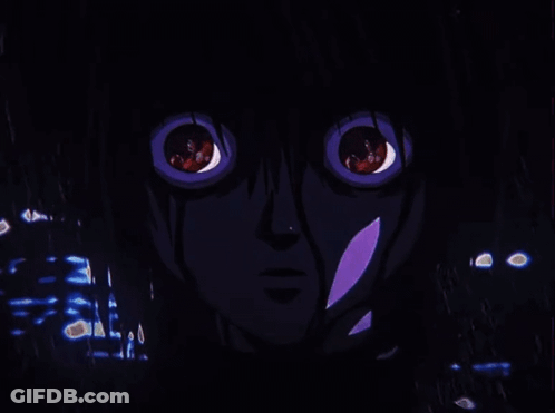 A Close Up Of A Person 'S Face With Red Eyes In A Dark Room GIF